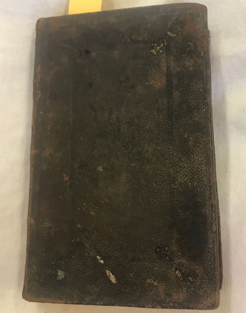 Photo of front cover of small brown leather volume